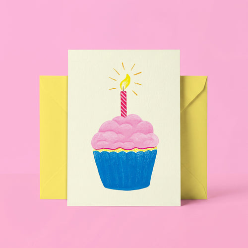 Greeting card with a cupcake and candle design on a pink background